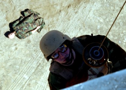 US Navy 050304-N-4374S-005 A member of Explosive Ordnance Disposal Mobile Unit Six (EODMU-6) is hoisted down to perform a Combat Search and Rescue (CSAR) exercise from a UH-3H Sea King helicopter