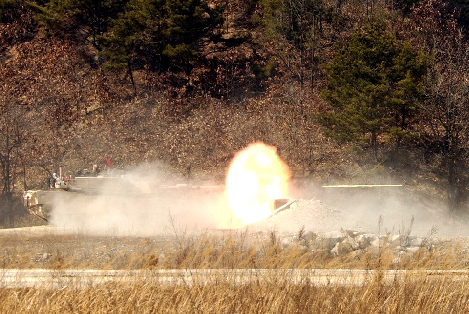 US Navy 050319-F-9629D-114 U.S. Army Soldiers, assigned to the 1st Squadron, 1st Calvary Regiment, fire the cannon from a M1A1 Abrams main battle tank during a live fire exercise at Rodriguez Live Fire Complex, Republic of Kore