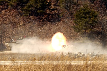 US Navy 050319-F-9629D-114 U.S. Army Soldiers, assigned to the 1st Squadron, 1st Calvary Regiment, fire the cannon from a M1A1 Abrams main battle tank during a live fire exercise at Rodriguez Live Fire Complex, Republic of Kore photo