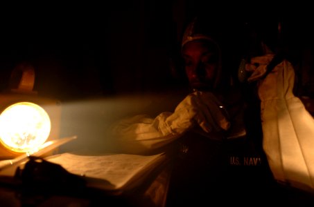 US Navy 050317-N-9866B-013 Seaman Latoya Burton communicates with her shipmates to determine where to send fire-fighting teams to extinguish simulated fires