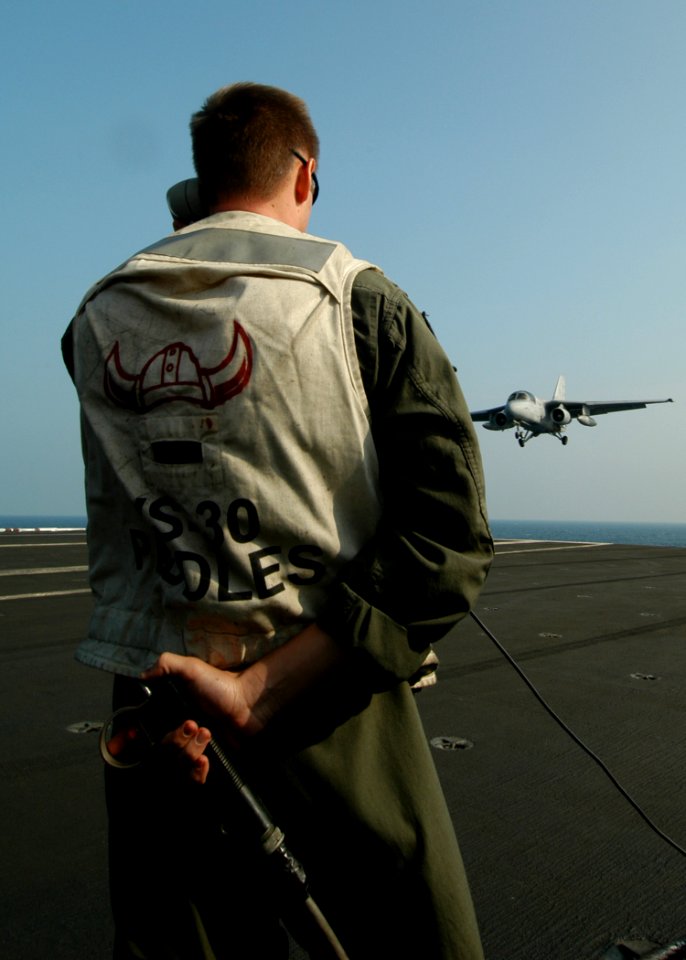 US Navy 050217-N-8704K-002 A Landing Signal Officer (LSO) signals a clear deck