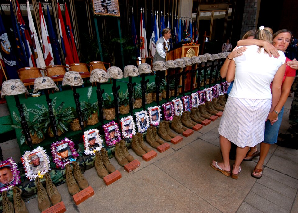 US Navy 050307-N-3019M-001 Family members console each other before a ceremonial formation of U.S. Marine Corps infantry equipment during the First Battalion, Third Marine's Memorial Service at the Hawaii State Capitol Bu