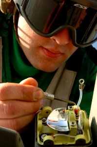 US Navy 050309-N-3488C-076 Aviation Structural Mechanic 2nd Class Keith Killian of Spring Creek, Nev., repairs a wing tip position light on an F-A-18F Super Hornet