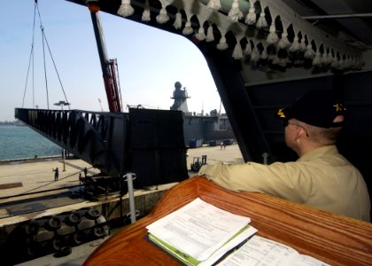 US Navy 050309-N-3241H-039 Executive Officer, USS Carl Vinson (CVN 70), Capt. DeWolfe Miller, supervises from the Quarterdeck, the raising of the brow as the Nimitz-class aircraft carrier USS Carl Vinson (CVN 70) prepares to de