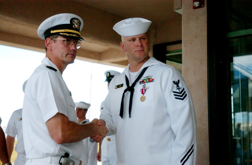 US Navy 050325-N-1906G-001 Capt. Bradley R. Gehrke shakes the hand of Hospital Corpsman 1st Class James H. Akin at an awards ceremony for Sailors assigned to USS San Francisco (SSN 711)