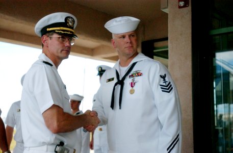 US Navy 050325-N-1906G-001 Capt. Bradley R. Gehrke shakes the hand of Hospital Corpsman 1st Class James H. Akin at an awards ceremony for Sailors assigned to USS San Francisco (SSN 711)