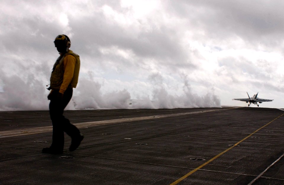 US Navy 050322-N-8158F-014 Aviation Boatswain's Mate 3rd Class Rocky Sutton of San Diego, Calif., prepares for the next launch as an F-A-18F Super Hornet, assigned to the Black Aces of Strike Fighter Squadron Four One (VF