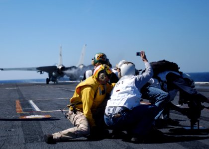 US Navy 050329-N-6484E-005 Flight deck personnel act as safety observers while distinguished visitors watch an F-14D Tomcat launch off the flight deck