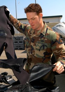 US Navy 050329-N-2385R-013 Information Systems Technician 2nd Class Joseph O'Brien, assigned to Explosive Ordnance Disposal Mobile Unit Five (EODMU-5), Detachment Five One, prepares to wash his dive gear to remove salt w