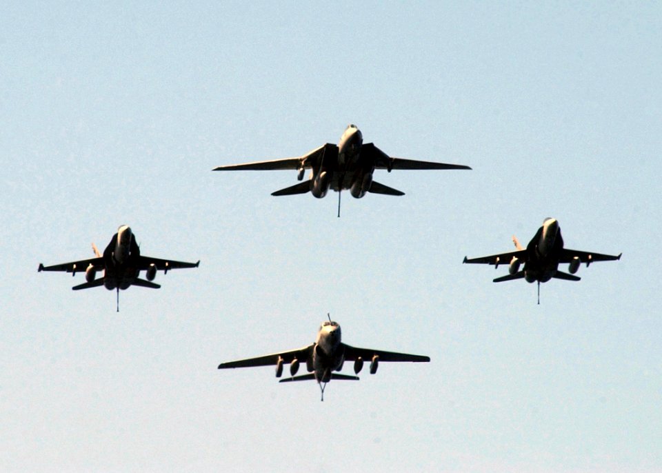 US Navy 050330-N-6363M-001 Tactical aircraft assigned to Carrier Air Wing Three (CVW-3), fly in formation with their tail hooks down, over the flight deck of the Nimitz-class aircraft carrier USS Harry S. Truman (CVN 75)
