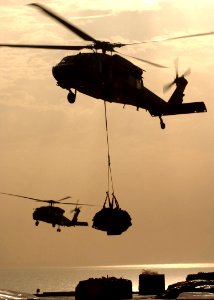 US Navy 050312-N-6363M-016 Two MH-60S Seahawk helicopters transfer stores from the Military Sealift Command (MSC) fast combat support ship USNS Arctic (T-AOE 8) to the flight deck aboard USS Harry S. Truman (CVN 75)