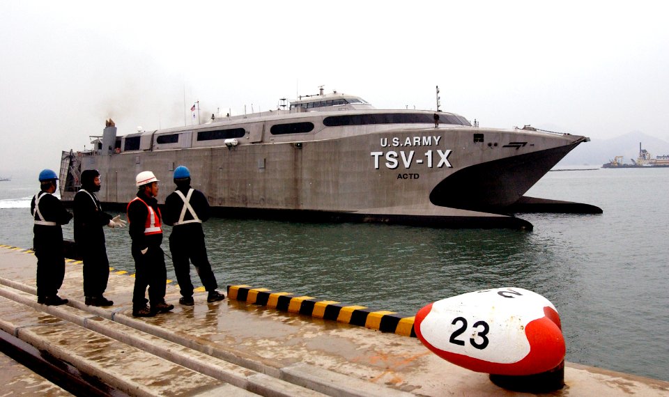 US Navy 050315-F-2902B-004 Korean contractors watch from shore as U.S. Army Theater Support Vessel TSV-1X Spearhead pulls into Gwangyang Port Terminal, Republic of Korea, to offload and on load combat tactical equipment