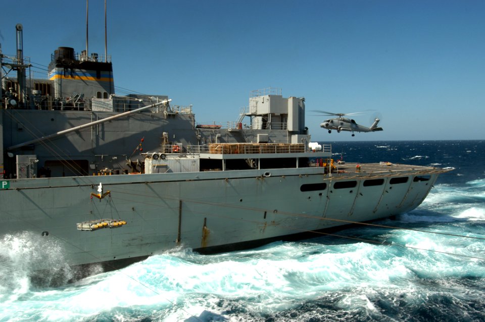 US Navy 050313-N-8704K-005 An SH-60B Seahawk delivers a pallet of ordnance to the Military Sealift Command (MSC) fast combat support ship USNS Supply (T-A0E 6) during a ammunition and ordnance off-load with USS John F Kennedy (