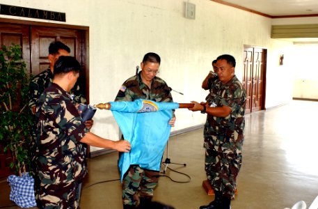 US Navy 050309-A-0000V-002 U.S. Army Pacific Deputy Commander, Maj. Gen. Stephen Tom, center, and Deputy Chief of Staff for Plans and Programs, Maj. Gen. Romeo Alamillo, right, furl the Exercise Balikatan 2005 colors in prepara