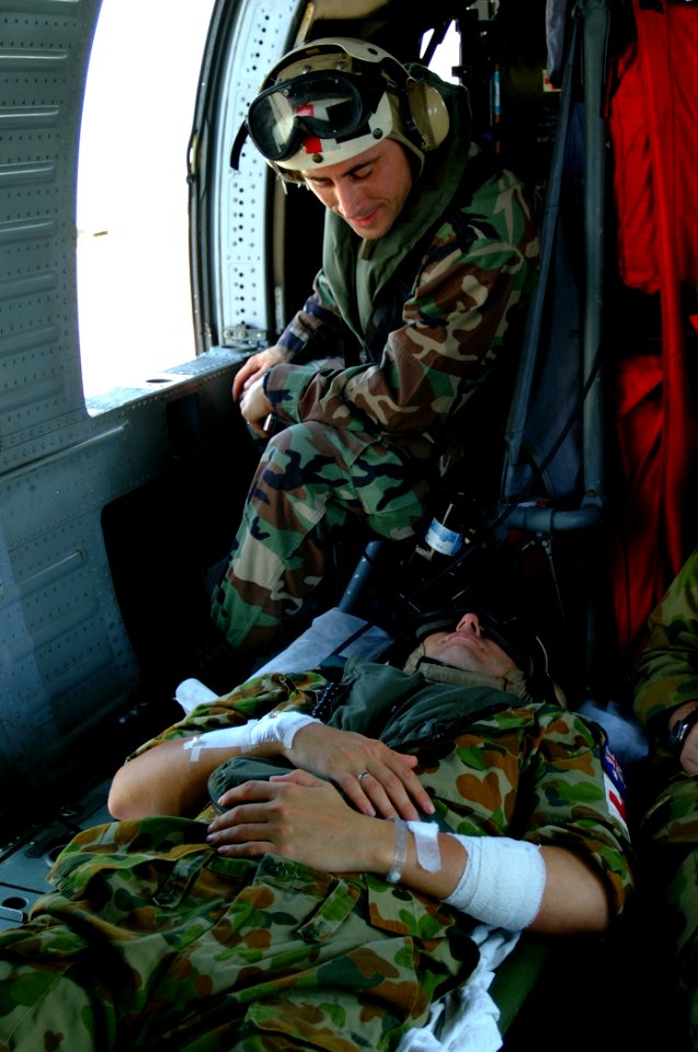 US Navy 050405-N-0357S-001 Chief Hospital Corpsman Patrick Nardulli talks to one of the two Australian patients being medically evacuated
