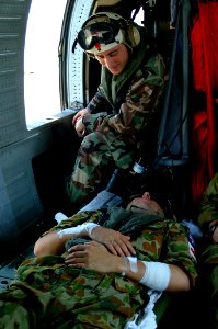 US Navy 050405-N-0357S-001 Chief Hospital Corpsman Patrick Nardulli talks to one of the two Australian patients being medically evacuated