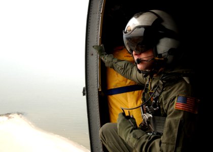 US Navy 050216-N-4374S-001 Aviation Electronics Technician 3rd Class Scott McCreedy views out the cabin door aboard a UH-3H Sea King helicopter en route to Naval Amphibious Base Little Creek, Va