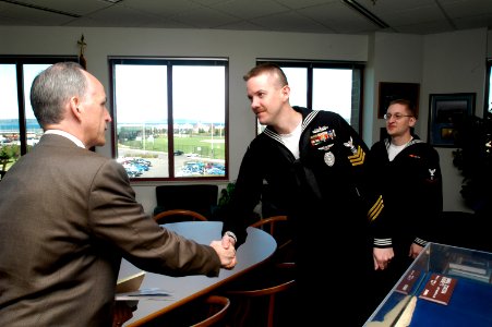 US Navy 050323-N-6477M-192 Master-at-Arms 1st Class Eric E. Slish, center, and Journalist 3rd Class Travis L. Clark meet with Rep. Adam Smith (D-WA) on board Naval Station Everett, Washington