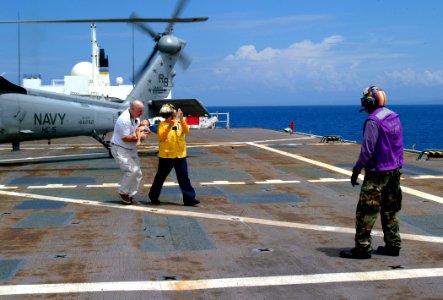 US Navy 050406-N-0357S-001 Dr. Dana Braner, a volunteer with the non-governmental organization Project HOPE, assisted by Information Systems Technician 2nd Class Sheronda Allen, carries an Indonesian child in respiratory distre