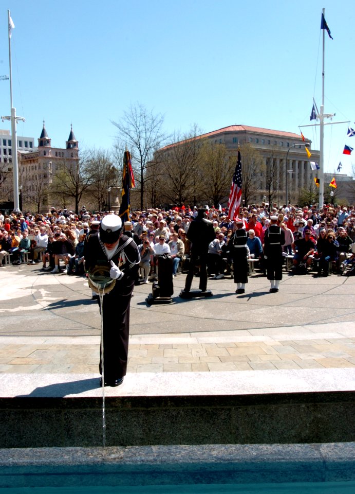 US Navy 050409-N-9693M-342 Seaman Melissa Jefferies, assigned to the U.S. Navy's Ceremonial Guard, decants water into one of four fountains during the 14th annual Blessing of the Fleet ceremony at the Navy Memorial in Washingto