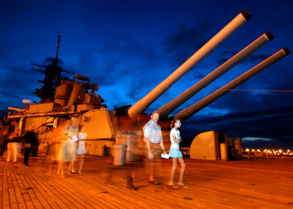 US Navy 050327-N-3019M-001 Service members and their families walk the deck of the battleship USS Missouri (BB 63) in the early morning hours to attend an Easter Sunrise Service