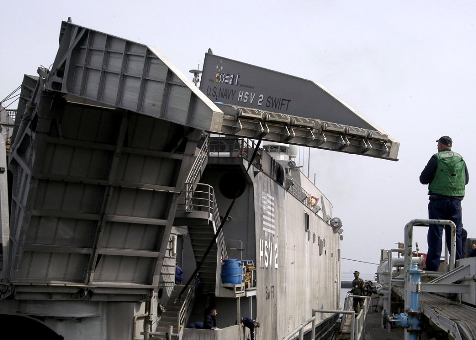 US Navy 050325-N-3503S-012 Chief Boatswain's Mate Mark Myers directs the lowering of the rear ramp of the High Speed Vessel Two (HSV 2) Swift