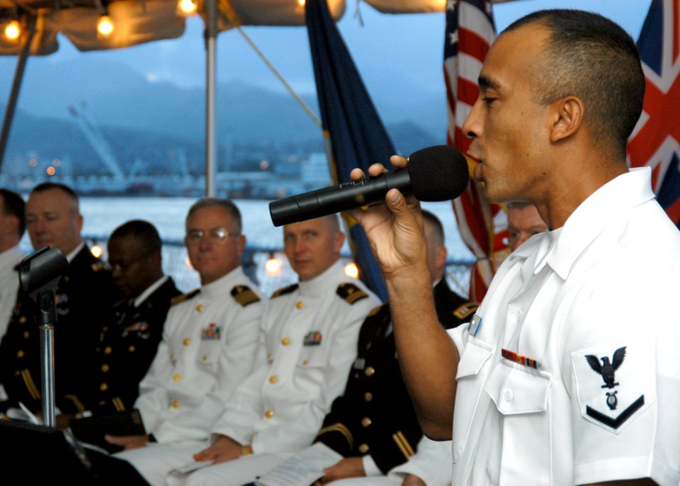 US Navy 050327-N-3019M-004 Musician 3rd Class Hilario Mireles sings a hymn at the Easter Sunrise Service aboard the battleship USS Missouri (BB 63)