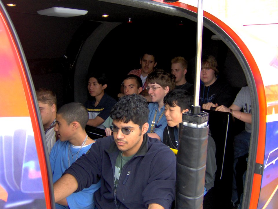 US Navy 050329-N-8110K-007 South Grand Prairie High School students prepare for their turn on the Navy's F-A-18 Hornet flight simulator during Navy Week Dallas