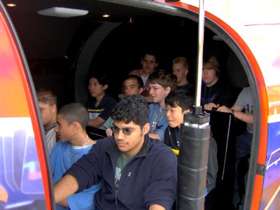 US Navy 050329-N-8110K-007 South Grand Prairie High School students prepare for their turn on the Navy's F-A-18 Hornet flight simulator during Navy Week Dallas