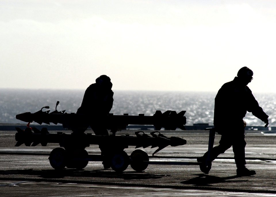 US Navy 050330-N-6363M-014 Two Aviation Ordnancemen transport a weapons cart loaded with AIM-9X Sidewinder missiles across the flight deck aboard the Nimitz-class aircraft carrier USS Harry S. Truman (CVN 75)