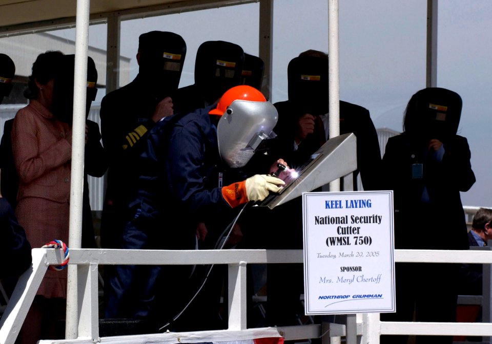 US Navy 050329-C-3550N-112 Billy Ross, a welder from Northrop Grumman Ship Systems, welds the initials of Meryl Chertoff, ship sponsor and wife of Secretary of Homeland Security Michael Chertoff, onto a placard