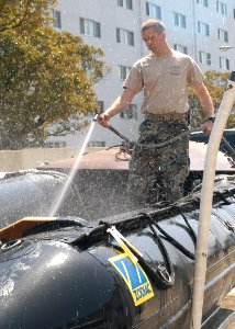 US Navy 050329-N-2385R-031 Gunners Mate 2nd Class Chandler J. Morris, assigned to Explosive Ordnance Disposal Mobile Unit Five (EODMU-5), Detachment Five One, washes out a Combat Rubber Raiding Craft