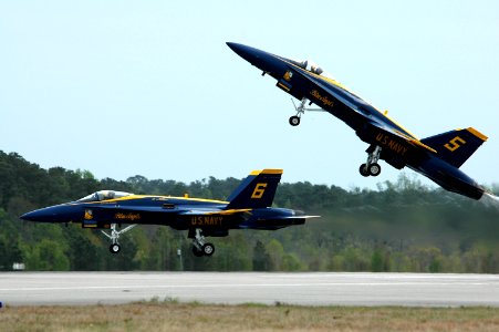 US Navy 050416-N-0295M-096 Lead Solo, Lt. Cmdr. Craig R. Olson, assigned to the U.S. Navy flight demonstration team, the Blue Angels, pulls his F-A-18A Hornet up sharply as the Opposing Solo, Lt. Cmdr. Theodore J. Steelman, con