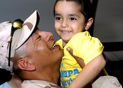 US Navy 050320-N-4048T-017 A Sailor assigned to Naval Expeditionary Logistics Support Force Reservists (NAVELSF), hugs a loved one after returning from deployment at the Air Mobility Command Terminal on board Naval Station Norf
