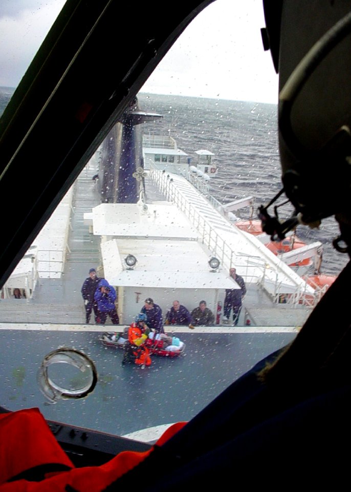 US Navy 050330-C-0000B-500 A U.S. Coast Guard Air Station Sitka, Alaska HH-60J Jayhawk helicopter crew circles the Alaska Marine Highways Systems ferry Kennicott prior to airlifting a 69-year-old patient 65-miles northwest of