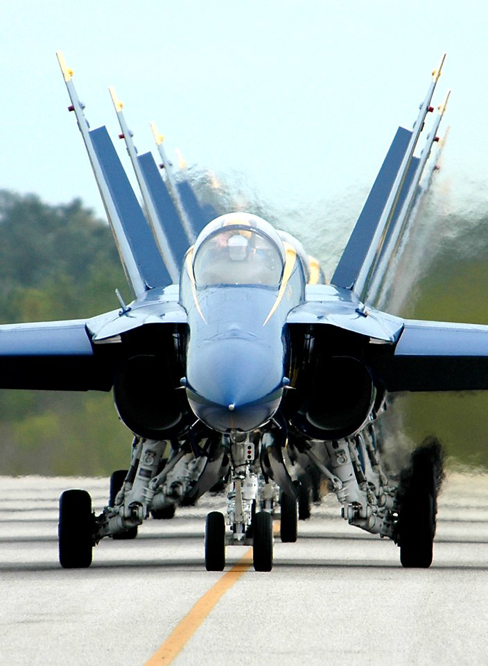 US Navy 050416-N-0295M-483 F-A-18A Hornets, assigned to the U.S. Navy flight demonstration team, the Blue Angels, taxi back to their flight line after performing before the crowd at the 2005 Coastal Carolina Air Show