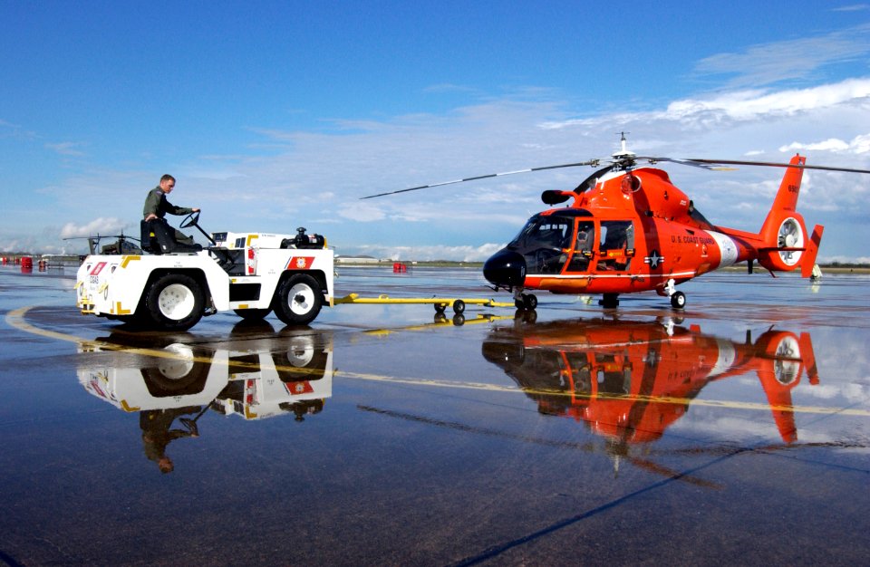 US Navy 050307-C-0379W-012 A member of Coast Guard Air Station Houston, Texas, maneuvers an HH-65B Dolphin rescue helicopter in position after a hard rain