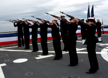 US Navy 050331-N-3390M-378 Sailors assigned to Ceremonial Rifle Guard, aboard the guided missile destroyer USS Momsen (DDG 92), render a 21-gun salute for a burial at sea ceremony to honor the passing of Capt. Charles Bowers Mo photo