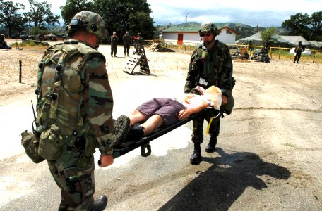 US Navy 050423-N-1722M-046 Sailors assigned to Naval Mobile Construction Battalion Two Five (NMCB-25) based at Fort McCoy, Wisc., help a wounded protester during exercise Bearing Duel at the Logistics Support Area