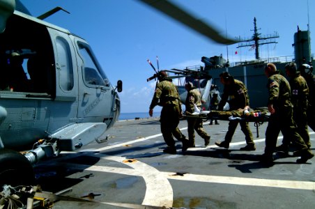 US Navy 050405-N-0357S-002 Australian medics carry one of two Australian service members who survived an April 2, 2005 crash of a Royal Australian Navy Sea King helicopter in Nias, Indonesia, to an awaiting MH-60S Seahawk helic