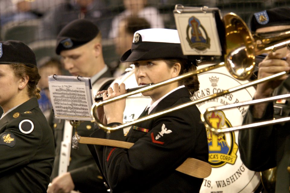US Navy 050405-N-6477M-071 Musician 3rd Class Selina Guzman plays the flute in the Joint Forces Band Northwest during the Boeing Salute to Armed Forces Night at SAFCO Field, Seattle, Wash