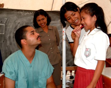 US Navy 050427-N-0357S-014 Dental Technician 3rd Class Ryan Hill teaches students the proper use of a toothbrush at a school on the island of Nias