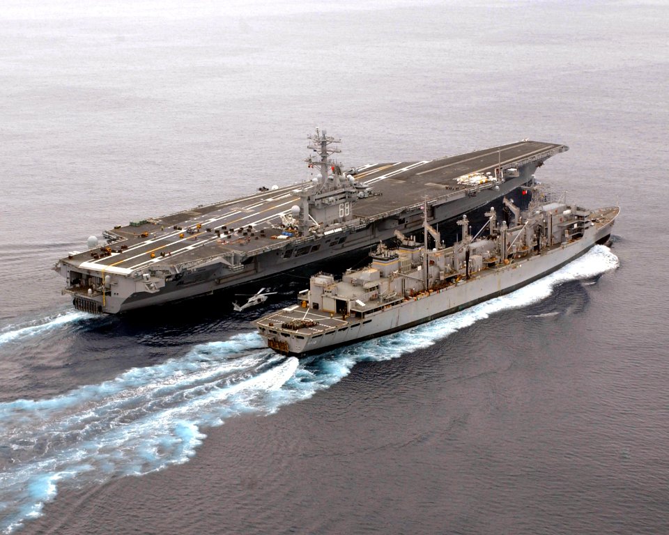 US Navy 050312-N-0413R-001 The Nuclear Powered Aircraft Carrier USS Nimitz (CVN 68) conducts a vertical replenishment (VERTREP) alongside the Military Sealift Command (MSC) fast combat support ship USNS Bridge (T-AOE 10)