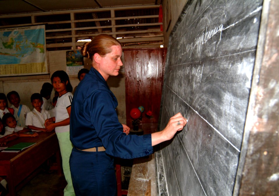 US Navy 050427-N-0357S-011 Navy Dietician, Lt. Teri Moraca writes the five food groups on a classroom chalkboard at a school on the island of Nias