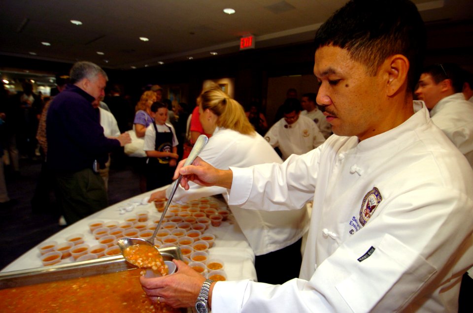 US Navy 050409-N-9693M-436 White House Chef Culinary Specialist 1st Class Ernesto Alvarez serves Navy Bean soup to visitors at the Navy Memorial