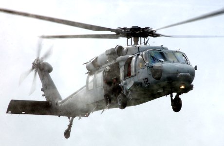 US Navy 050413-N-7615S-036 Search and rescue swimmers, assigned to Helicopter Sea Combat Support Squadron Three (HSC-3), prepare to jump out of an MH-60S Seahawk helicopter