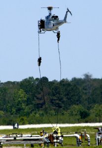 US Navy 050507-N-0295M-005 U.S. Marines repel from a UH-1N Huey helicopter during the Marine Air Ground Task Force (MAGTF) demonstration at the 2005 Marine Corps Air Station Cherry Point air show photo