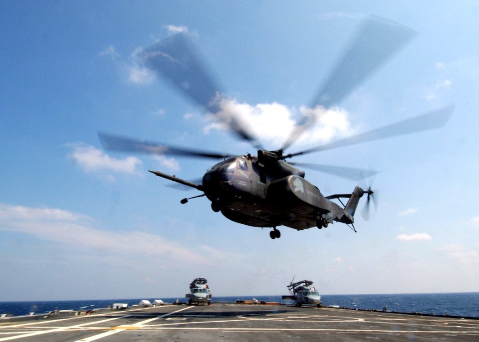 US Navy 050508-N-4374S-005 An MH-53E Sea Dragon helicopter, assigned to the Vanguards of Helicopter Mine Countermeasures Squadron One Four (HM-14), launches from the flight deck of the amphibious transport dock ship USS Trenton