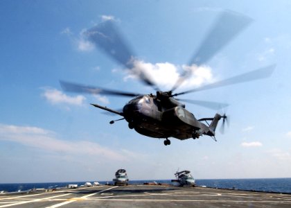 US Navy 050508-N-4374S-005 An MH-53E Sea Dragon helicopter, assigned to the Vanguards of Helicopter Mine Countermeasures Squadron One Four (HM-14), launches from the flight deck of the amphibious transport dock ship USS Trenton
