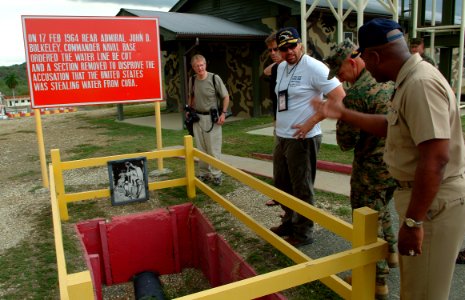 US Navy 050512-N-0962S-093 Commander, U.S. Naval Base, Guantanamo Bay, Capt. L. J. McCoy shows country music star Toby Keith the pipe Adm. John D. Bulkeley broke in 1964